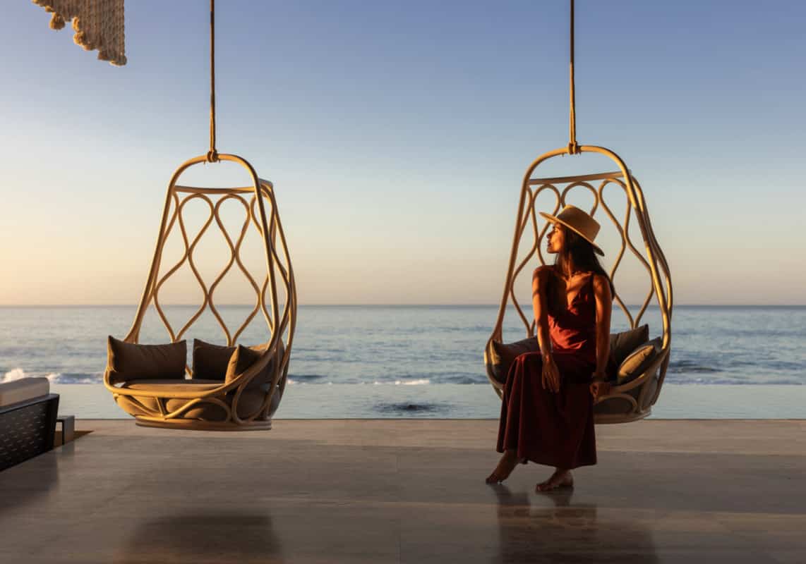 Sitting in hanging chair by the beach
